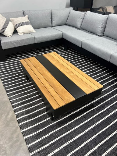 Black and Natural Striped Graphite Rug top view of rug with outdoor coffee table on top