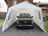 Gazebo Penguin Carport in White and Clear front view of white model with open front door and vehicle inside