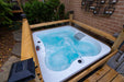 Canadian Spa Company - Manitoba 4-Person 15-Jet Portable Hot Tub top angle view of tub outdoors with water bubbling