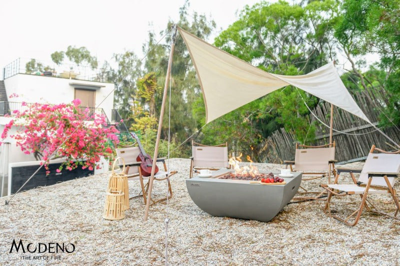 Backyard Lifestyles Modeno - Florence Fire Table - Natural Concrete front view of fire pit outdoors under canopy with seating