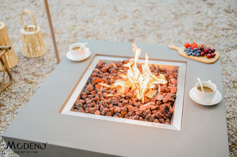 Backyard Lifestyles Modeno - Florence Fire Table - Natural Concrete top view of fire table with open flame with cups of coffee sitting on edge