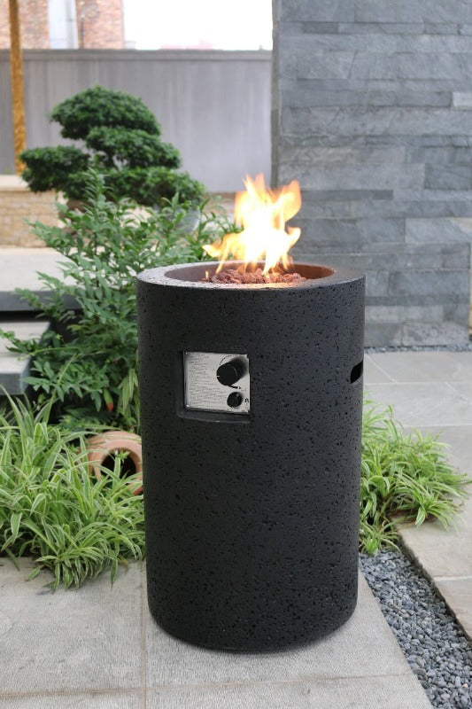 Backyard Lifestyles Modeno Lava Tube Concrete Propane Fire Pit in Black front view of fire pit with flame outdoors