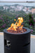 Backyard Lifestyles Modeno Lava Tube Concrete Propane Fire Pit in Black front close view of fire pit with lava rocks and flame 