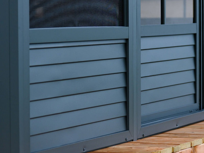 Gazebo Penguin Florence Wall Mounted Solarium Polycarbonate Roof close up of slate side panels on a deck